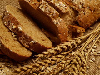 Fresh sliced bread with grains and ears