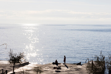 Glittering star shaped sun rays on water waves in the small coastal town of Patresi on the island of Elba in Italy