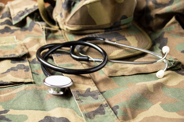 Shot of stethoscope lies on the uniform of a US soldier. The concept of health care, military...