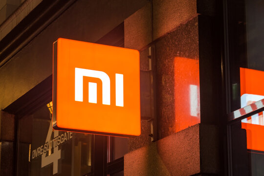 Oslo, Norway - September 24, 2021: Logo of Xiaomi on retail store at night. Xiaomi is a Chinese electronics company headquartered in Beijing.