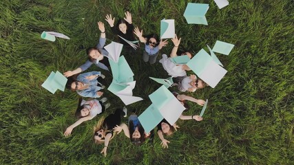 Students toss exercise books on their last day of school.