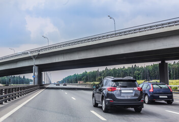 Cars move along a two-level suburban highway.