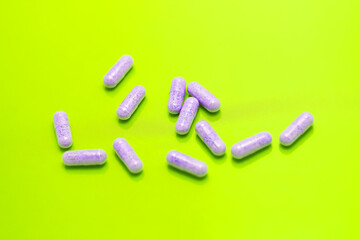 Medical pills background. Capsules on green background. multicolored pills and capsules on a green background.