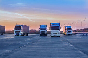 Trucks in a parking lot on a suburban highway © Yuri Bizgaimer