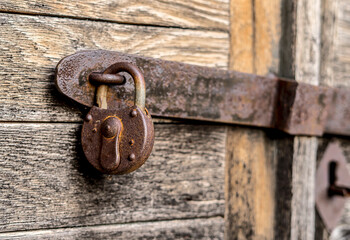 Old key lock on a wooden door.