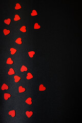Red hearts on a black background. Valentine's Day.