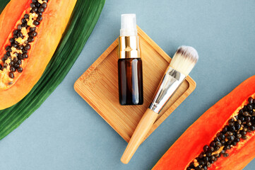 Organic skin care beauty treatment, fresh cosmetic product in dropper bottle, fresh ripe papaya...