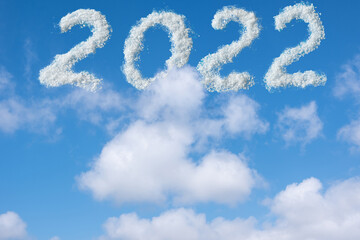 Naklejka na ściany i meble The date is 2022 written in white clouds in the blue sky. Christmas sky background