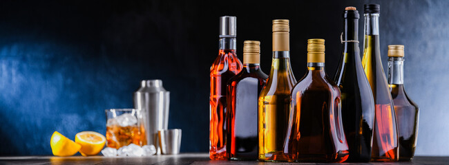 Bottles of assorted alcoholic beverages and bartender