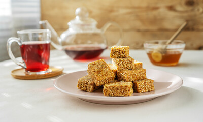 Eastern sweets - sesame mini-bars with main ingredients and fruit tea