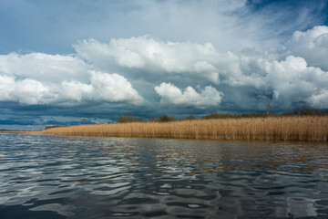 cloudy landscape in the lake and the sea with kayaks