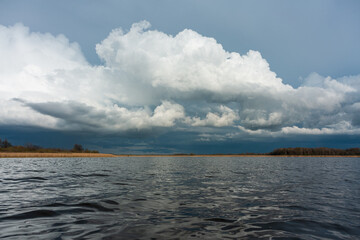 cloudy landscape in the lake and the sea with kayaks