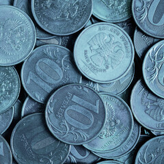Russian coins of 10 rubles. Blue tinted square illustration. Economy and the Central Bank of Russia. Textured ruble surface. Close up flat lay