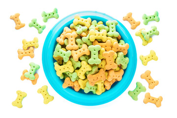 Colorful Low-fat Mini Biscuit with vegetable on blue bowl, dog food Isolated on white background.