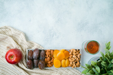Dried dates, fruits and nuts for Jewish holiday Tu Bishvat celebration. Top view modern background.