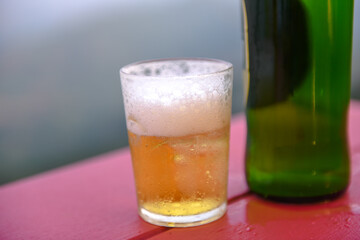 glass of beer on a green background