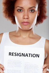 Serious young Black woman tendering her resignation