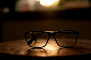 Modern style. Sunglasses on wooden with soft light from the sunset.