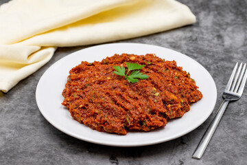 Chili paste on a dark background. spicy paste. A kind of adjika. Turkish cuisine appetizers. Horizontal view. Close up