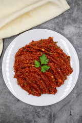 Chili paste on a dark background. spicy paste. A kind of adjika. Turkish cuisine appetizers. Top view. Close up