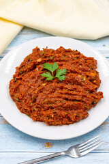 Chili paste on a wooden background. spicy paste. A kind of adjika. Turkish cuisine appetizers. Vertical view. Close up