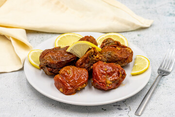 Dried stuffed peppers on a stone background. Rice stuffed sundried red pepper. Turkish cuisine appetizers. Kuru biber dolması. Horizontal view. close up