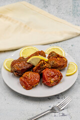 Dried stuffed peppers on a stone background. Rice stuffed sundried red pepper. Turkish cuisine appetizers. Kuru biber dolması. Vertical view. close up