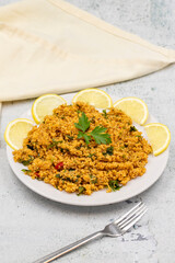 Bulgur salad (kisir) on a stone background. Traditional delicious food. Turkish cuisine appetizers. Vertical view. close up
