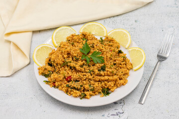 Bulgur salad (kisir) on a stone background. Traditional delicious food. Turkish cuisine appetizers. Horizontal view. close up