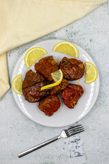 Dried stuffed peppers on a stone background. Rice stuffed sundried red pepper. Turkish cuisine appetizers. Kuru biber dolması. Top view. close up