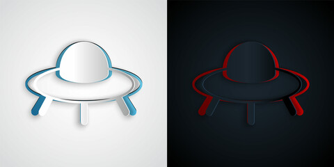 Paper cut UFO flying spaceship icon isolated on grey and black background. Flying saucer. Alien space ship. Futuristic unknown flying object. Paper art style. Vector