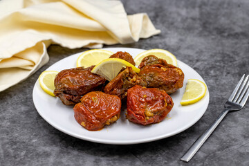 Dried stuffed peppers on a dark background. Rice stuffed sundried red pepper. Turkish cuisine appetizers. Kuru biber dolması. Horizontal view. close up