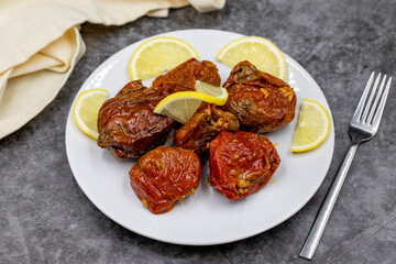 Dried stuffed peppers on a dark background. Rice stuffed sundried red pepper. Turkish cuisine appetizers. Kuru biber dolması. Horizontal view. close up