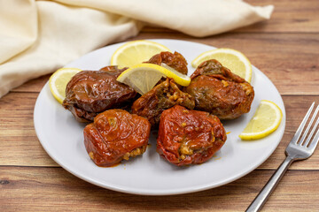 Dried stuffed peppers on a wooden background. Rice stuffed sundried red pepper. Turkish cuisine appetizers. Kuru biber dolması. Horizontal view. close up