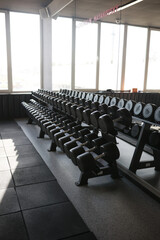 Black dumbbells in the gym Large mirrors indoors