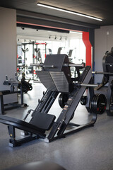 Fototapeta na wymiar Exercise machine for the legs in the gym