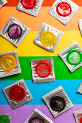 Super safe banana and strawberry flavored condoms with pleasant smell on a rainbow background. Contraceptives are made of natural rubber latex, high quality material. Natural feel and safety.
