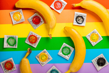 Super safe banana and strawberry flavored condoms with pleasant smell on a rainbow background....