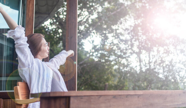 Country home with happy healthy woman feeling good during vacation in natural resort bulcony. Simple lifestyle people in fresh cozy outdoor park comfortable relaxing morning - Powered by Adobe