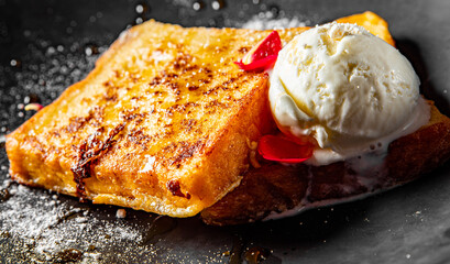 french toast with ice cream on black plate