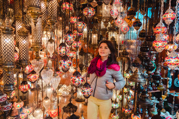 Fototapeta na wymiar Young woman looking at lamps in the store