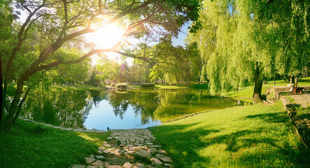 Beautiful colorful summer spring natural landscape with a lake in Park surrounded by green foliage...