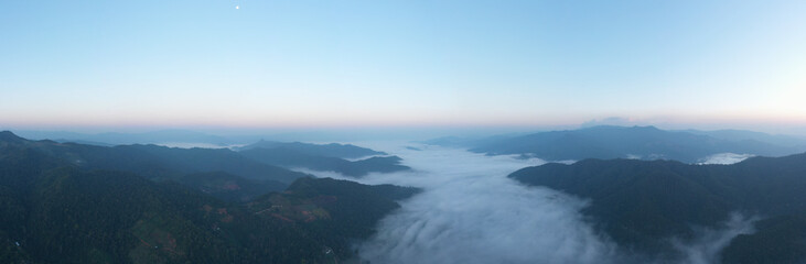 aerial view from drone panoramic landscape morning natural light blue sky and mountain range with fog in valley at chiang rai Thailand,