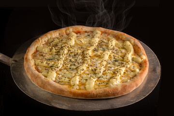 Four cheese pizza coming out of the oven. Brazilian pizza