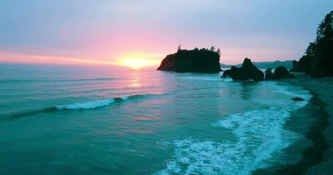 Aerial Beautiful Shot Of Rocks At Ruby Beach, Drone Flying Forward Over Ocean During Sunset
