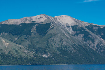 Landscape lake mountains cliff peak 	
