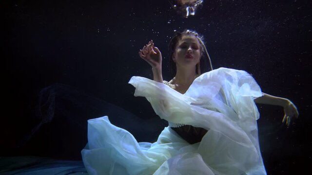 princess of underwater kingdom on bottom of magical sea or ocean, romantic fairytale shot