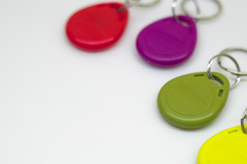 Magnetic key for the door intercom. Multicolored programmable chip keys. Copy space, selective focus