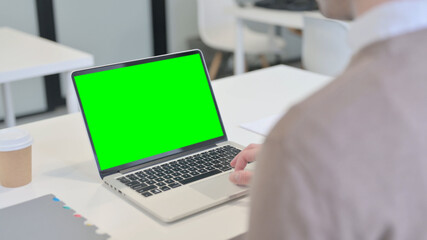 Rear View of Man using Laptop with Open Screen