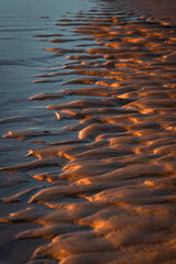 Baltic Sea rocks and beach sand at sunset